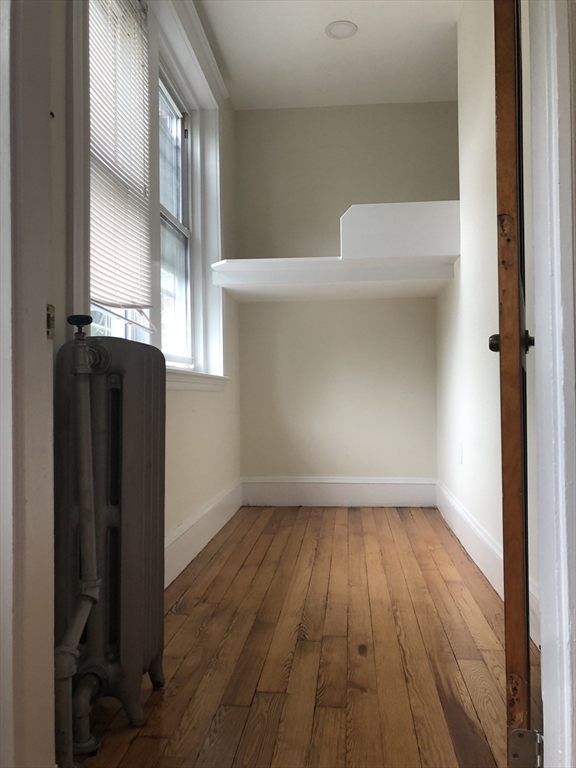 16 Copenger Street, Unit 2 Boston, MA 02120 - Photo 5 of 11 a view of empty room with wooden floor and fan