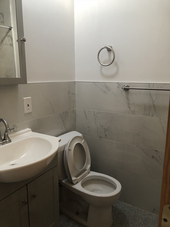 16 Copenger Street, Unit 2 Boston, MA 02120 - Photo 7 of 11 a bathroom with a sink toilet and a mirror