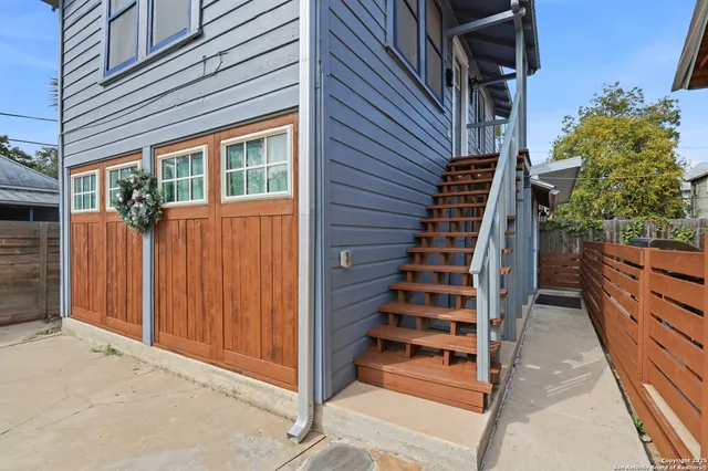 an aerial view of residential houses with outdoor space and street view