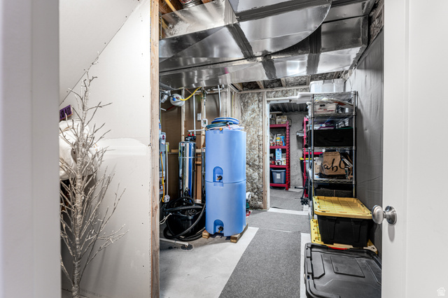 313 Old Maple Road South Weber, UT 84405 - Photo 17 of 35 Utility room featuring exposed ductwork, concrete flooring, and ample storage shelving
