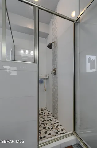 a view of a porch with chairs and potted plants