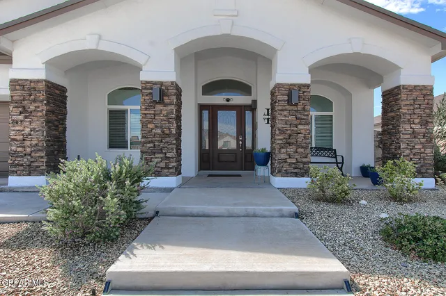 a view of a dining room with furniture and a chandelier