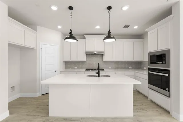 a view of a kitchen with a sink and a stove