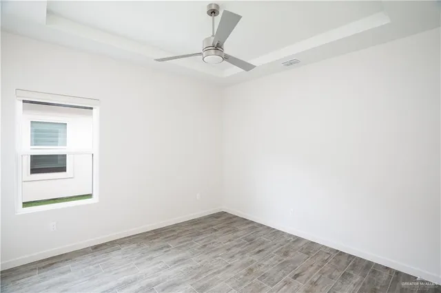 a view of a small space with wooden floor and a window