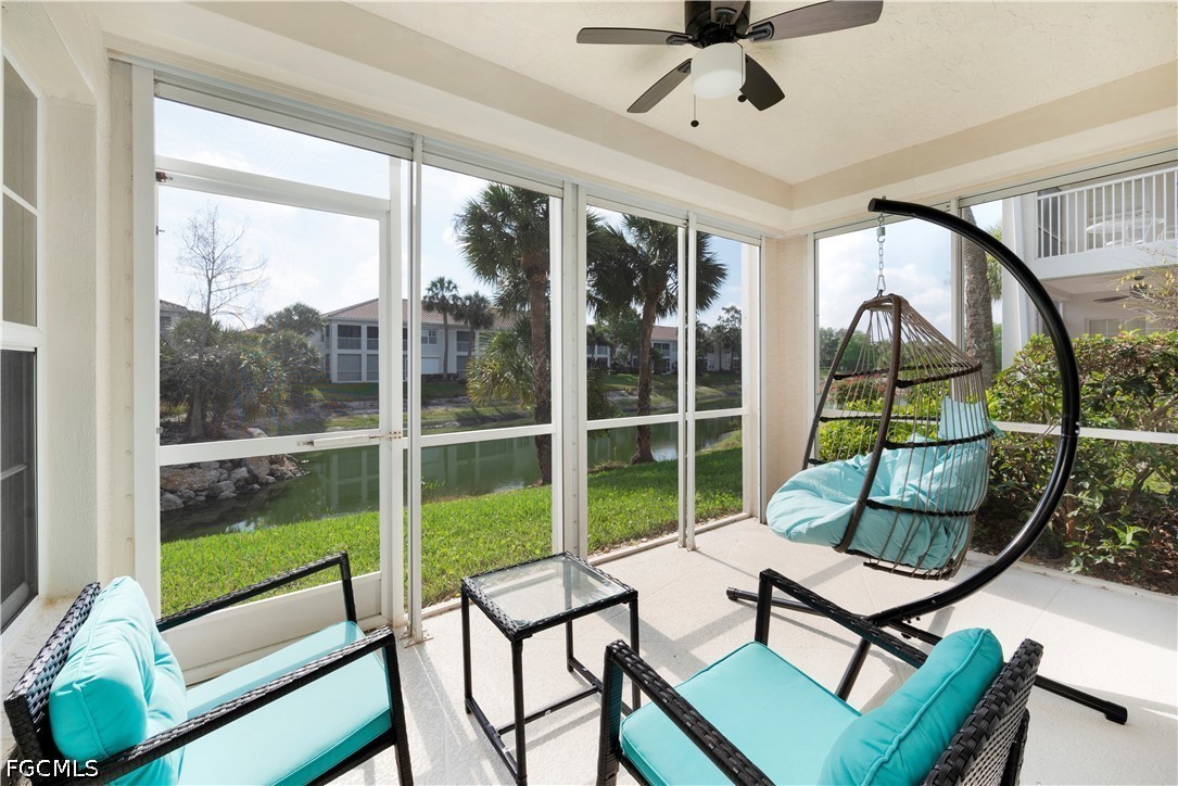 6800 Satinleaf Road South, Unit 104 Naples, FL 34109 - Photo 2 of 12 a living room with hardwood floor and a floor to ceiling window