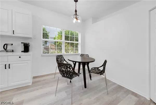 a dining room with furniture and window