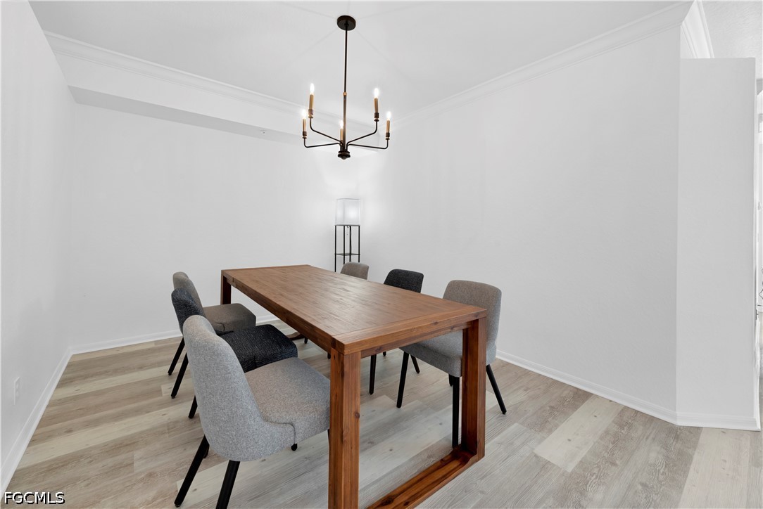 6800 Satinleaf Road South, Unit 104 Naples, FL 34109 - Photo 6 of 12 a view of a dining room with furniture and wooden floor