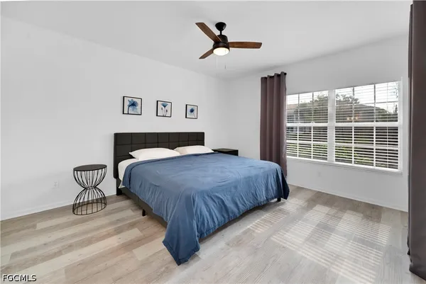 a spacious bedroom with a bed and a window