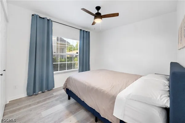 a bedroom with a bed and window