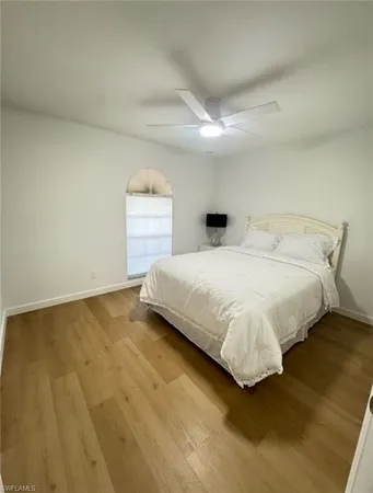 a bedroom with a bed and a night stand