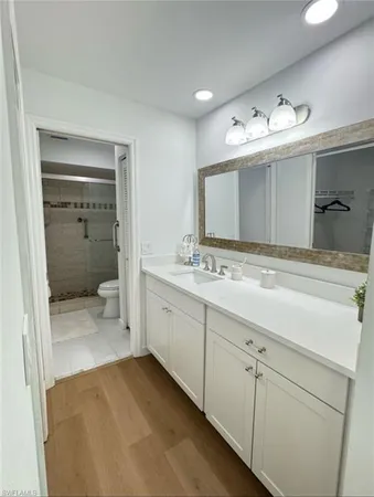 a bathroom with a double vanity sink and a mirror