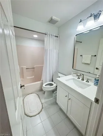 a bathroom with a granite countertop sink toilet a mirror and shower