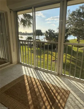 a view of a balcony with a floor to ceiling window next to a yard