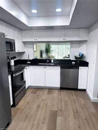 a kitchen with granite countertop a stove and a sink