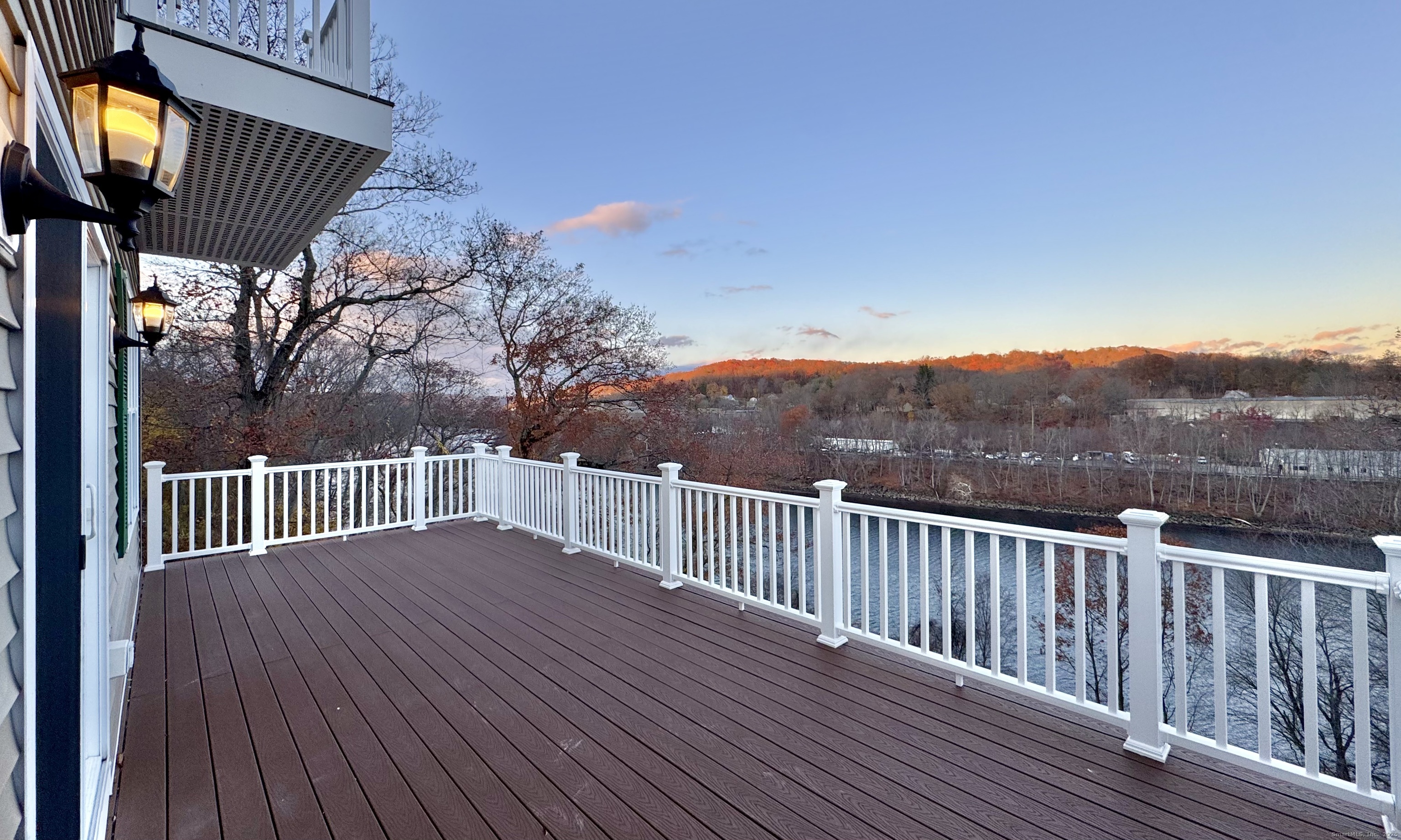 a view of balcony with wooden floor and fence
