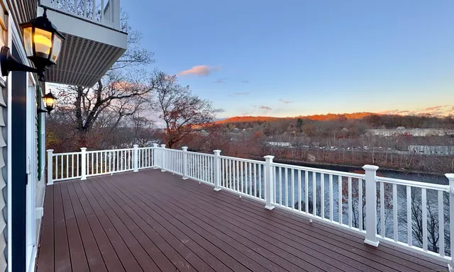 a view of balcony with wooden floor and fence