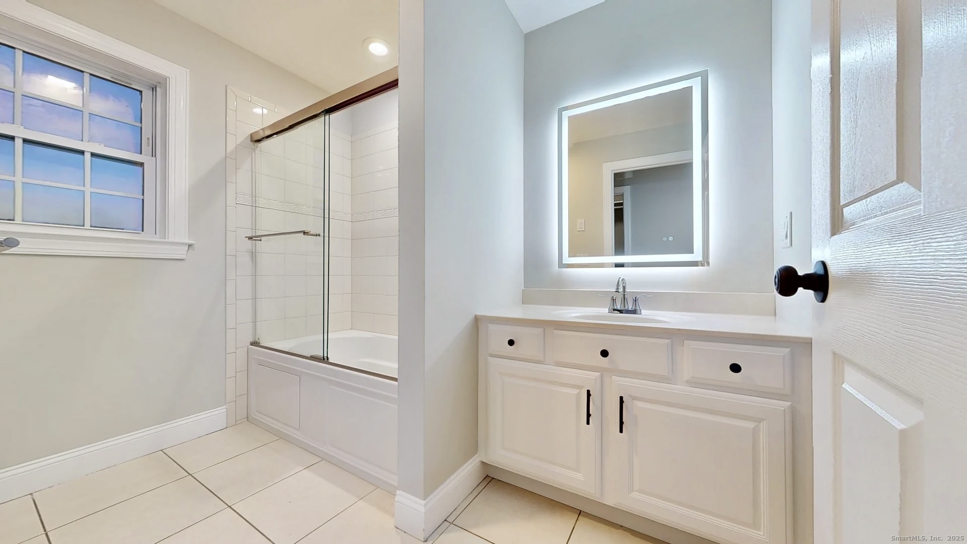 112 River Road Shelton, CT 06484 - Photo 23 of 37 a bathroom with a sink a mirror and shower