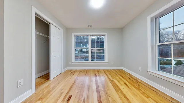 a view of wooden floor in a room next to a window
