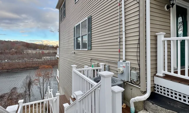 a view of a balcony with chair and wooden floor