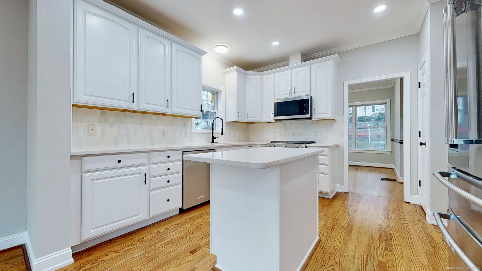 112 River Road Shelton, CT 06484 - Photo 5 of 37 a kitchen with white cabinets and stainless steel appliances