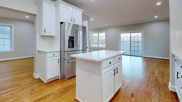 a large kitchen with stainless steel appliances granite countertop a sink stove and refrigerator