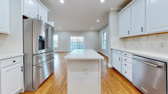 a kitchen with cabinets and stainless steel appliances