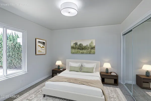 a view of a room with wooden floor and white walls