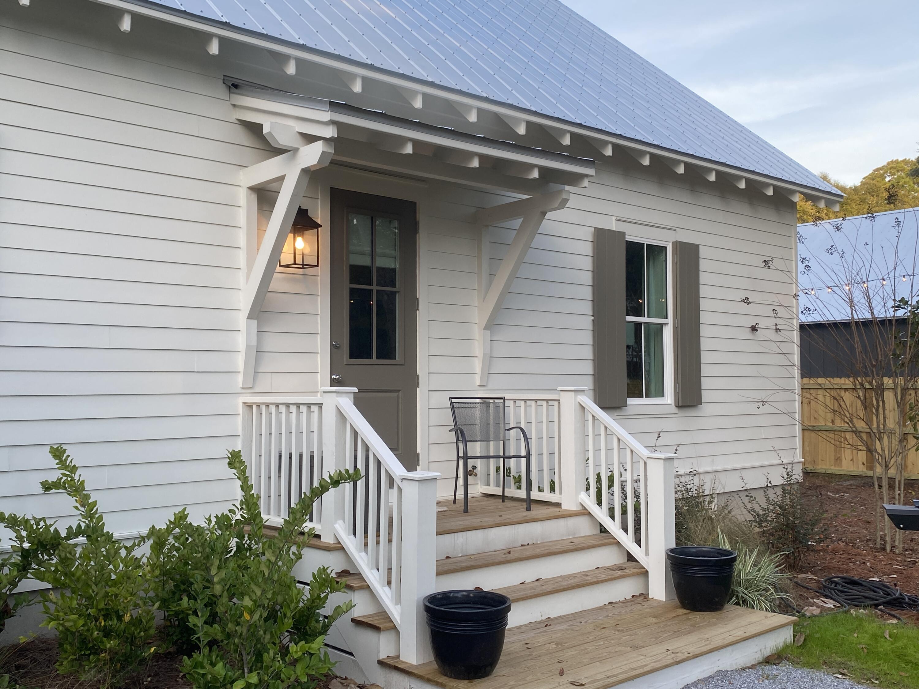 426 Morrison Avenue Santa Rosa Beach, FL 32459 - Photo 2 of 18 a view of a house with porch and wooden floor