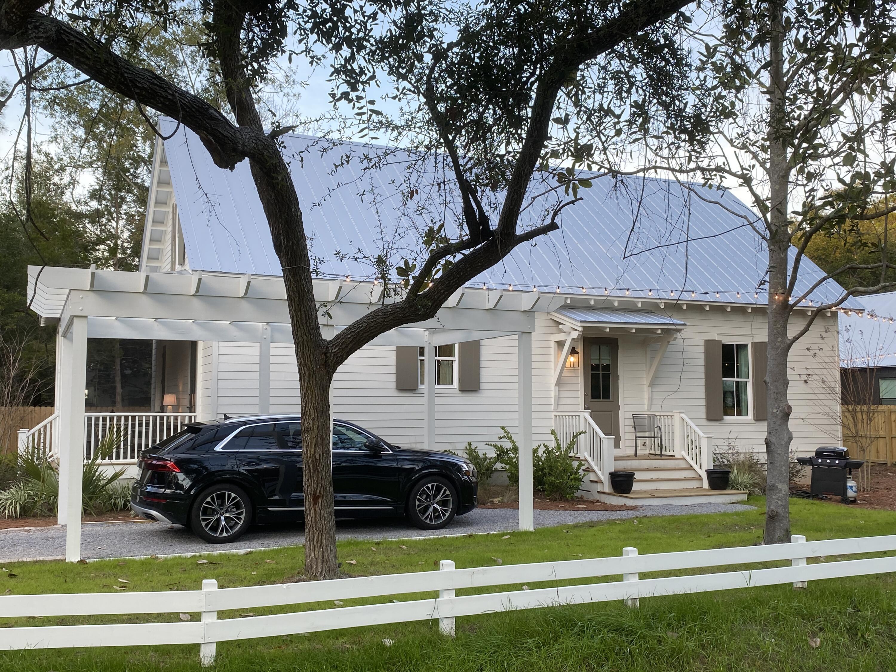 426 Morrison Avenue Santa Rosa Beach, FL 32459 - Photo 4 of 18 a view of a house with a swimming pool table and chairs