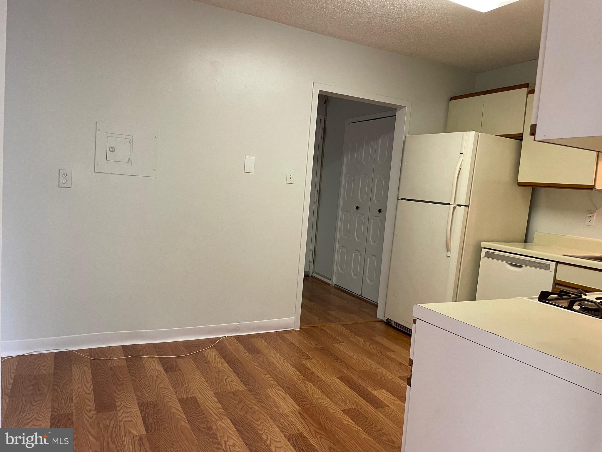 5225 Pooks Hill Road, Unit 228S Bethesda, MD 20814 - Photo 11 of 28 a view of a kitchen with refrigerator and wooden floor
