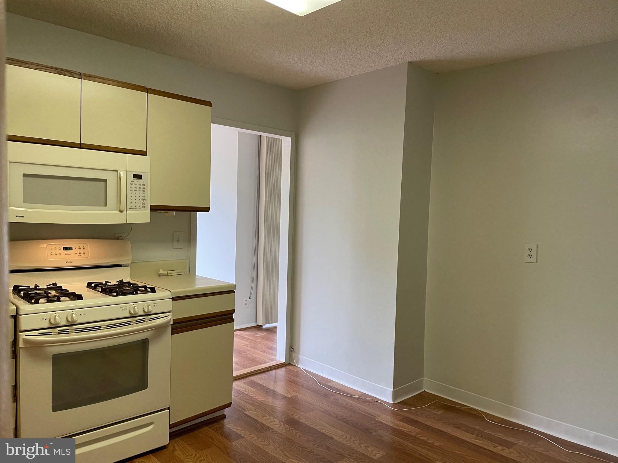 5225 Pooks Hill Road, Unit 228S Bethesda, MD 20814 - Photo 12 of 28 a kitchen with stainless steel appliances a stove a microwave and a refrigerator