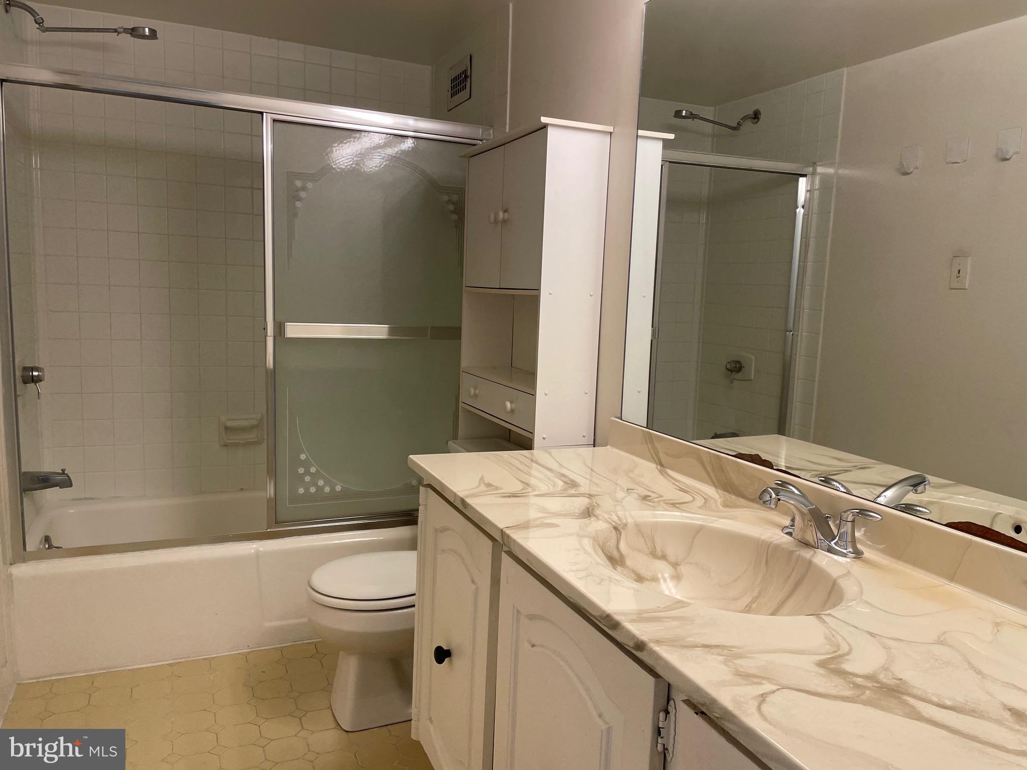 5225 Pooks Hill Road, Unit 228S Bethesda, MD 20814 - Photo 13 of 28 a bathroom with a granite countertop sink toilet and shower