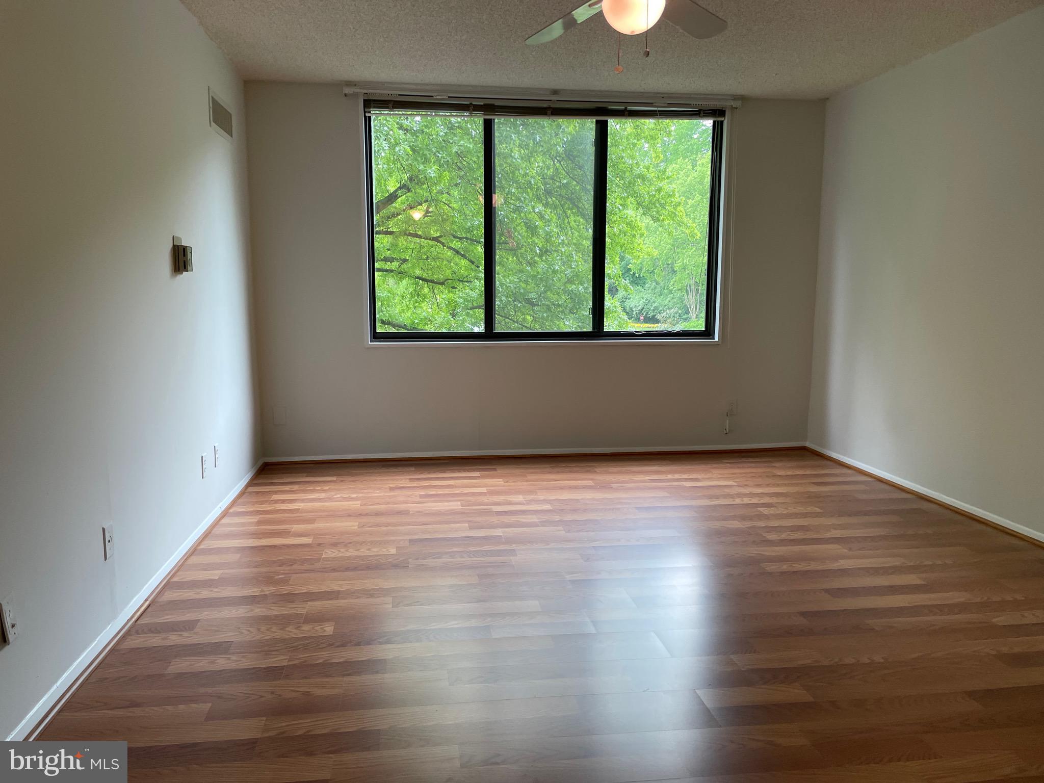 5225 Pooks Hill Road, Unit 228S Bethesda, MD 20814 - Photo 14 of 28 an empty room with wooden floor and windows