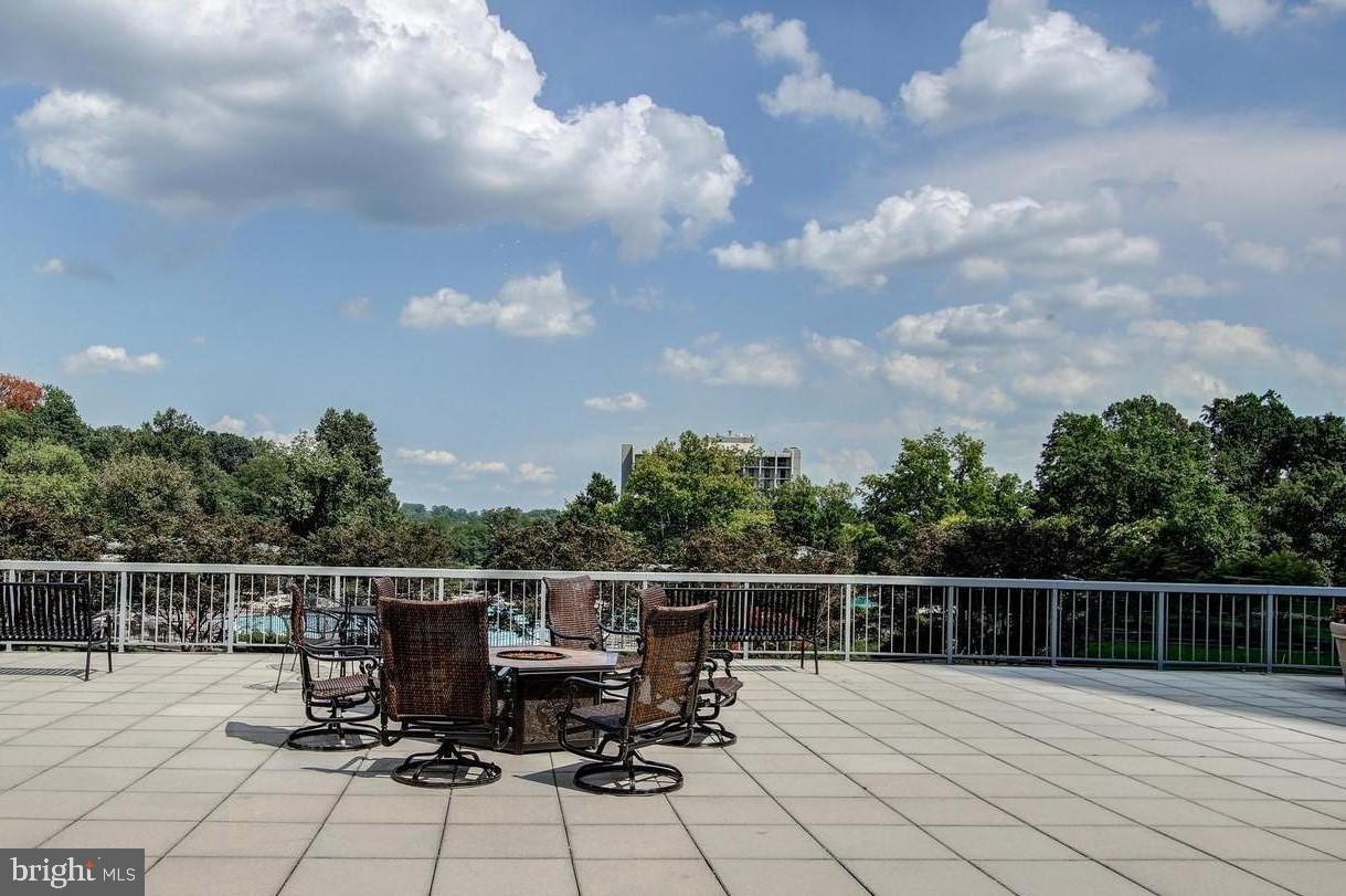 5225 Pooks Hill Road, Unit 228S Bethesda, MD 20814 - Photo 22 of 28 a roof deck with table and chairs