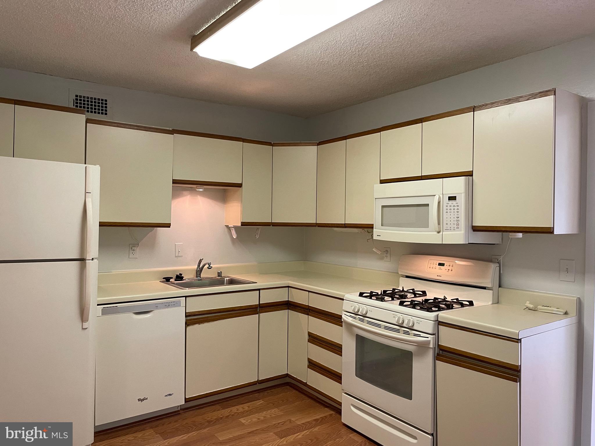 5225 Pooks Hill Road, Unit 228S Bethesda, MD 20814 - Photo 9 of 28 a kitchen with cabinets appliances a sink and a counter space