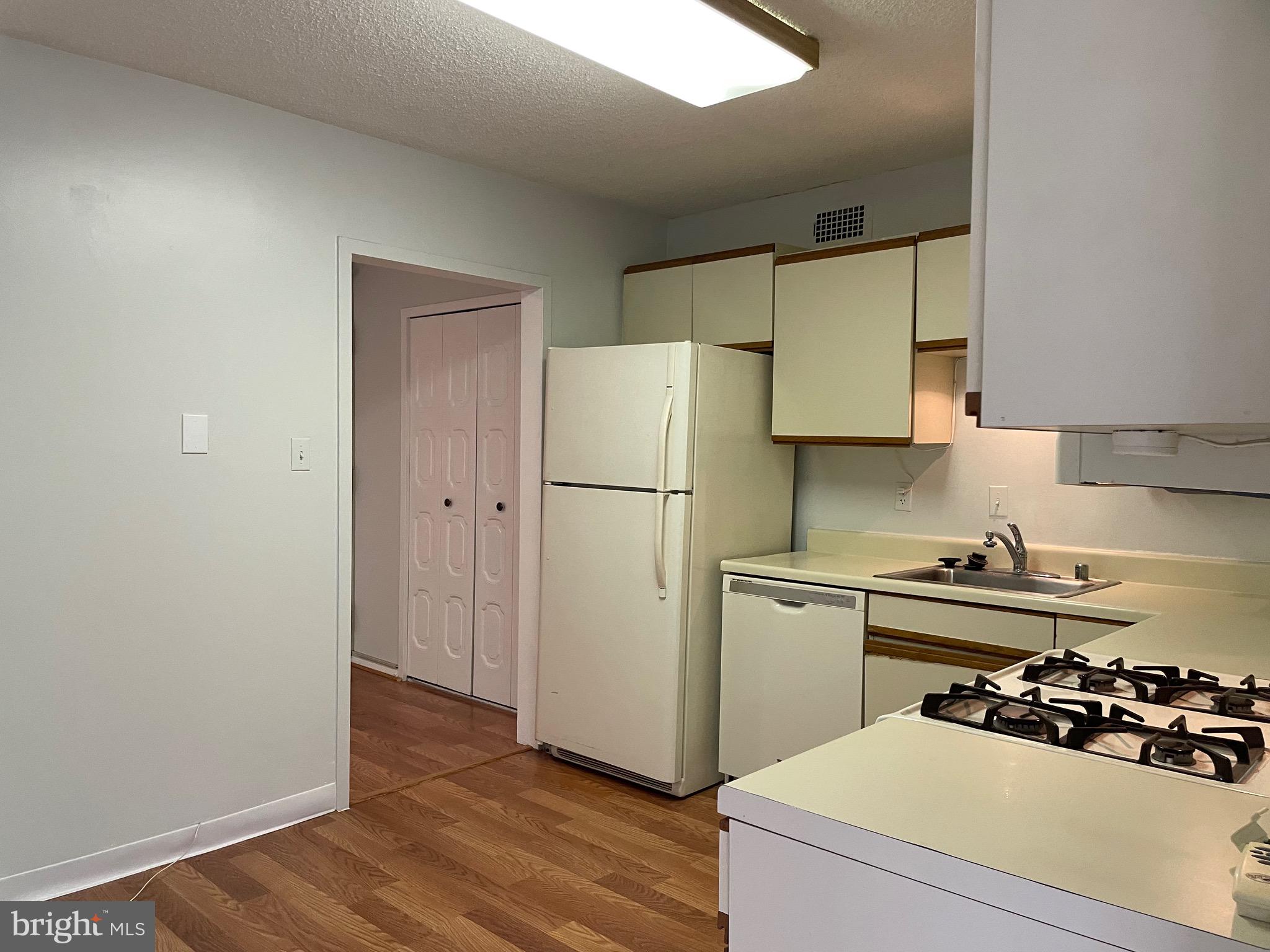 5225 Pooks Hill Road, Unit 228S Bethesda, MD 20814 - Photo 10 of 28 a kitchen with a refrigerator and a stove top oven