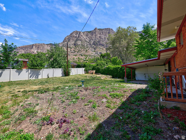 1272 Cook Street Ogden, UT 84404 - Photo 42 of 46 Spacious backyard offering significant potential, a partial privacy fence, and a covered patio area