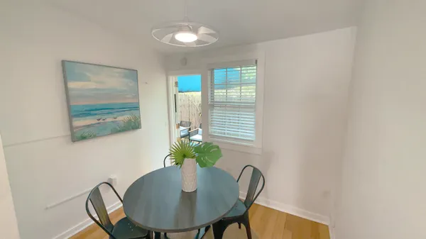a view of a dining room with furniture and wooden floor