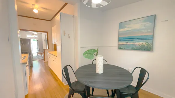 a view of a chairs and table in the back yard of the house