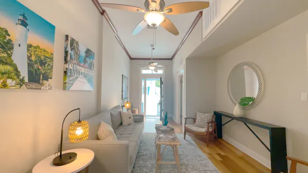 a living room with furniture and a chandelier
