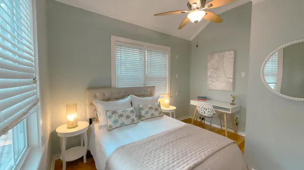 a bedroom with a bed and a chandelier