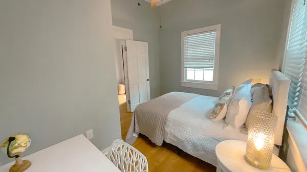 a bedroom with bed and a window
