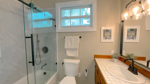 a bathroom with a sink toilet and shower