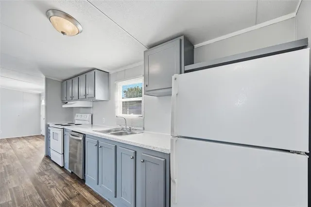 a kitchen with stainless steel appliances a refrigerator and a sink