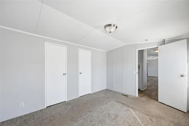 a view of a big room with closet and windows