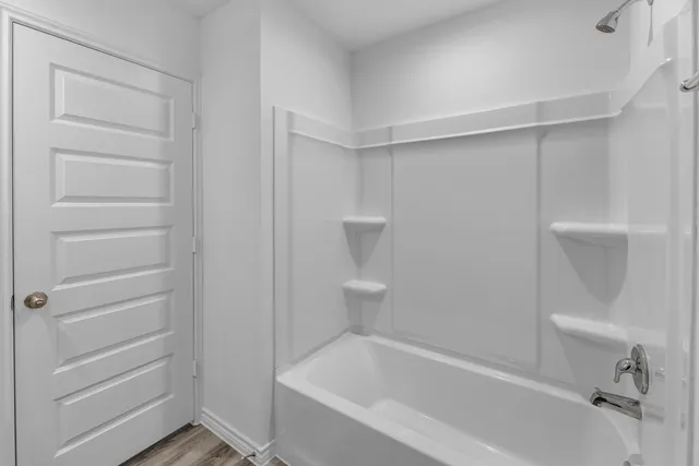 a bathroom with a bathtub and toilet