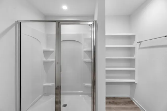 a bathroom with a glass shower door