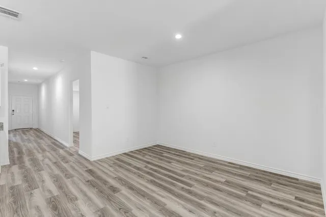 a view of room with wooden floor