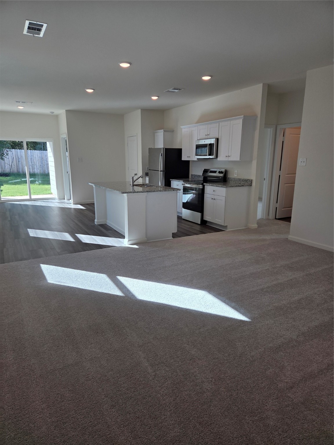 632 Craven Street Conroe, TX 77316 - Photo 2 of 2 a view of kitchen with stainless steel appliances refrigerator microwave and cabinets