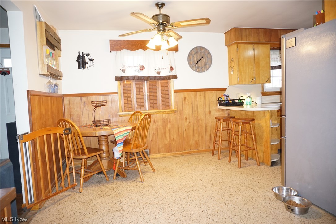 4611 8th Street Northwest Canton, OH 44708 - Photo 7 of 29 Dining space featuring ceiling fan and indoor bar